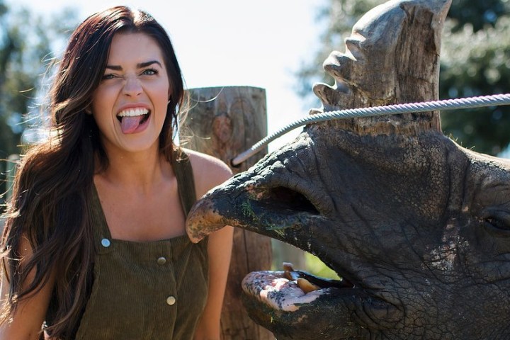 a woman holding an animal